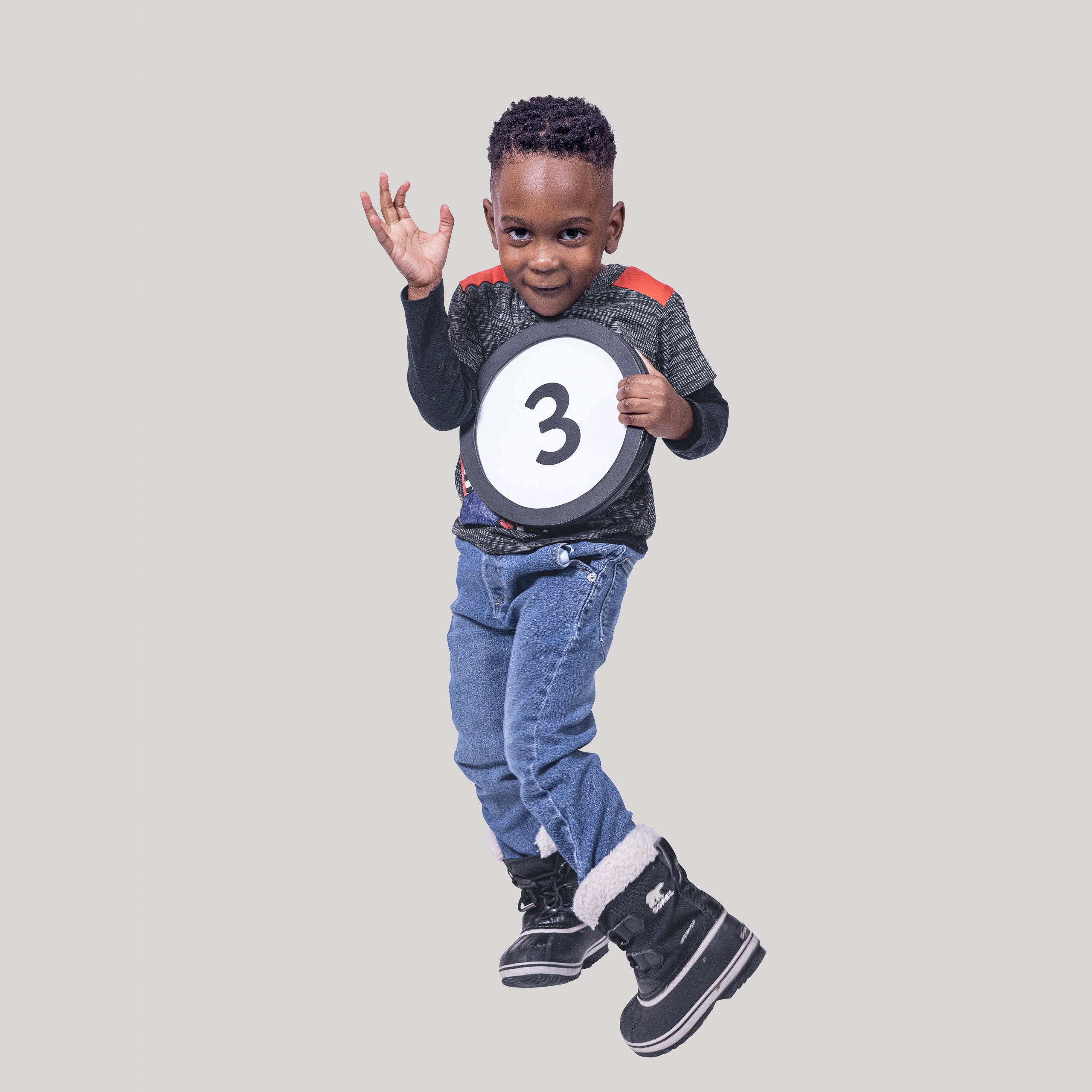 3-year-old boy holds the number 3 in the 1 to Infinity, MIT portrait series by Danny Goldfield.