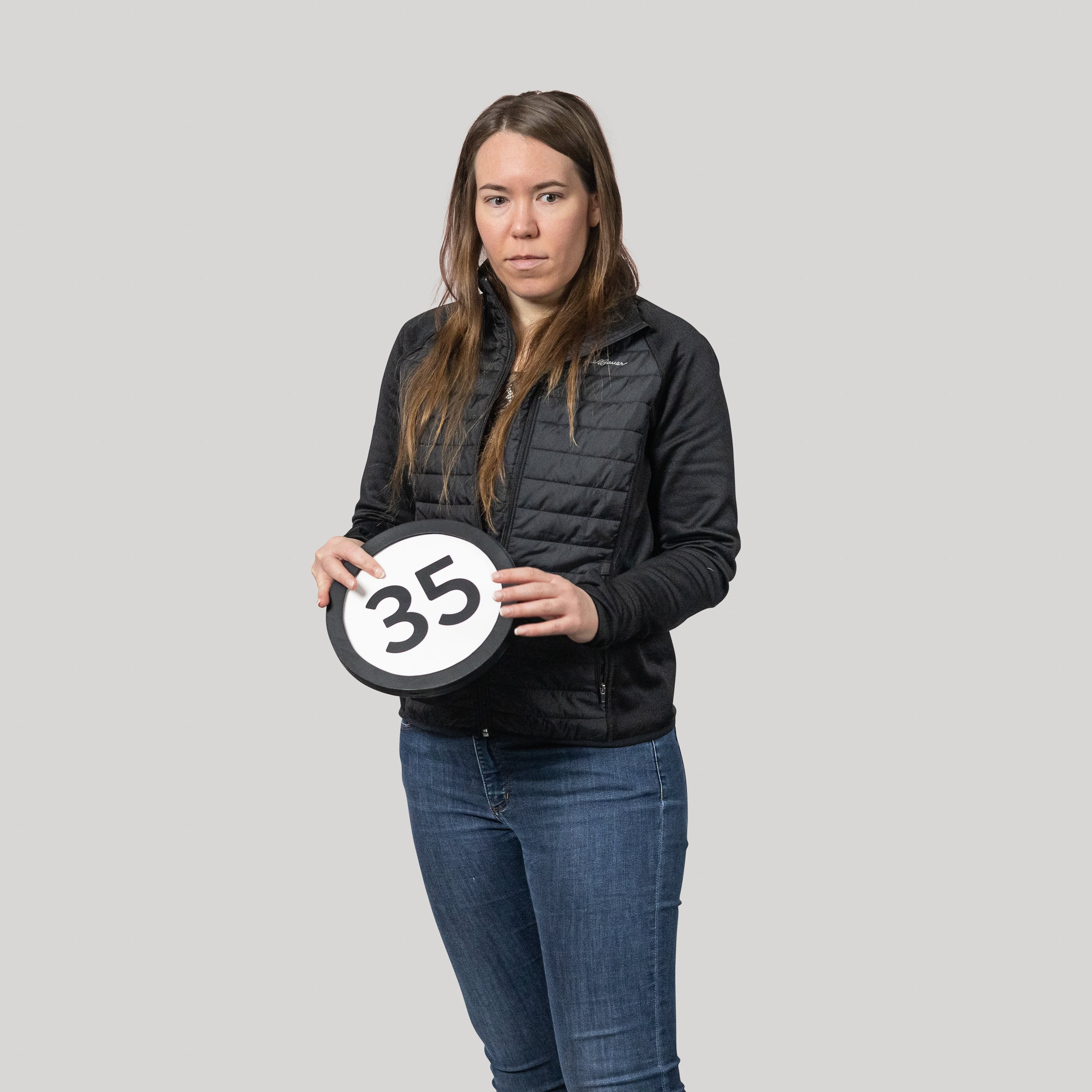 35-year-old woman holds the number 35 in the 1 to Infinity, MIT portrait series by Danny Goldfield.