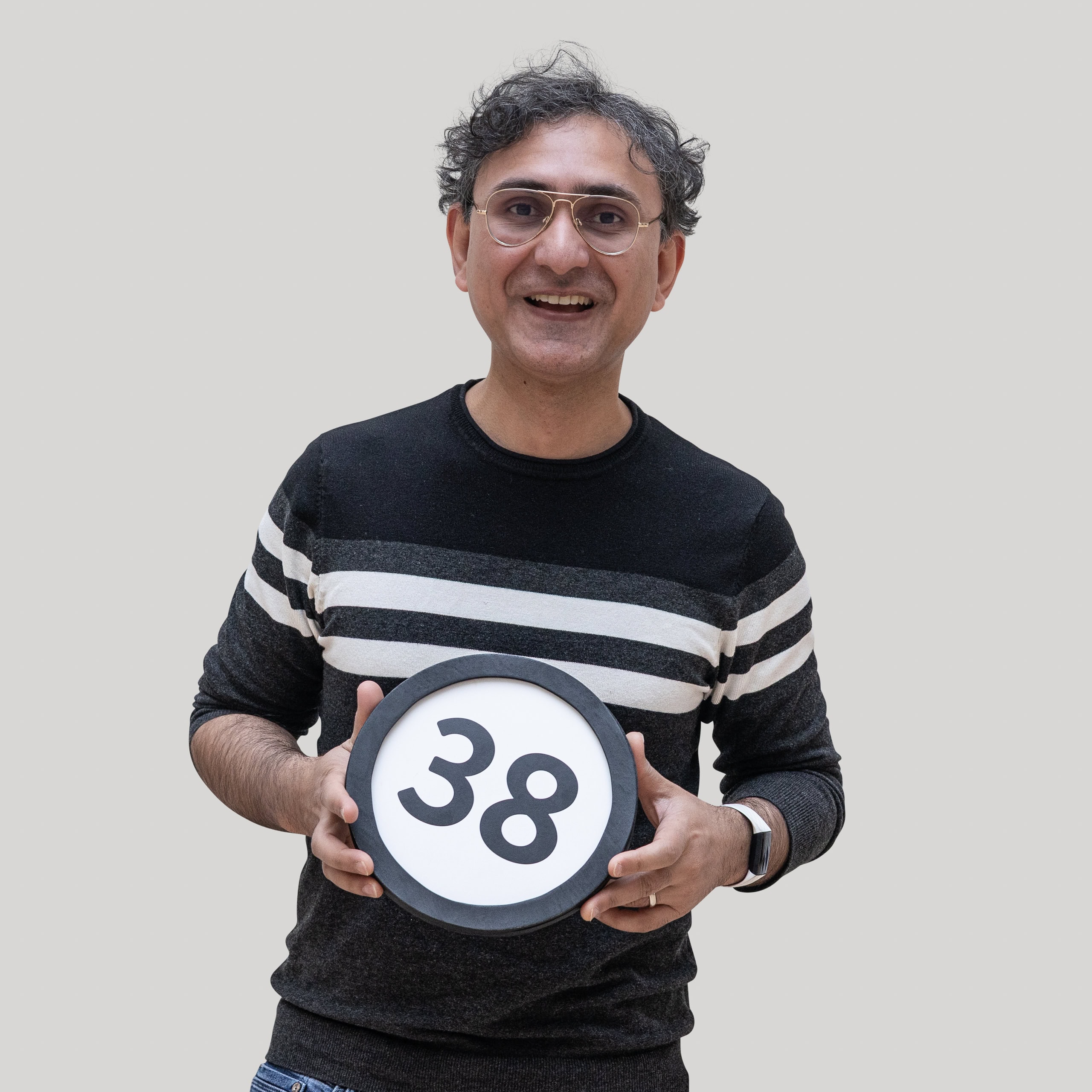 38-year-old man holds the number 38 in the 1 to Infinity, MIT portrait series by Danny Goldfield.