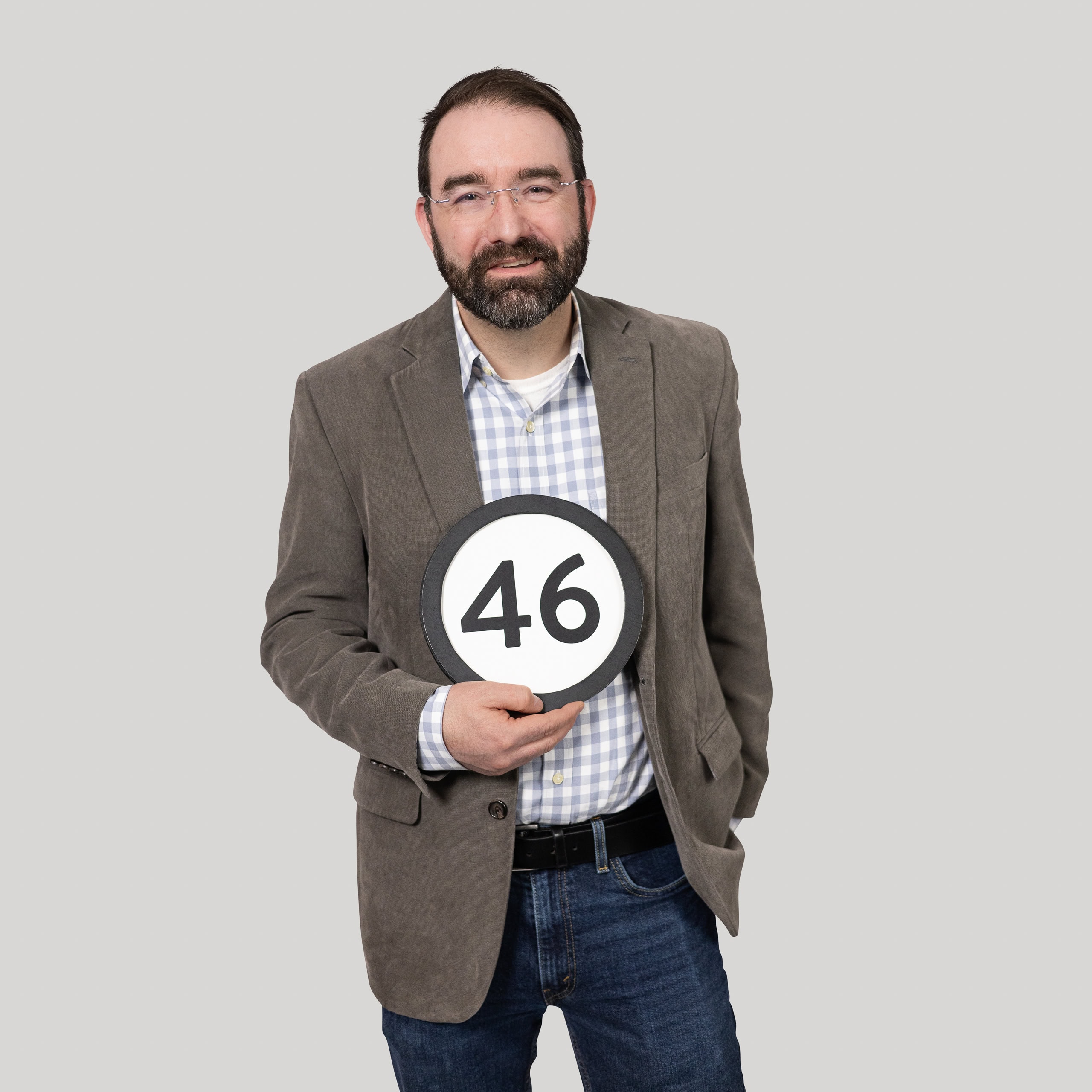 46-year-old man holds the number 46 in the 1 to Infinity, MIT portrait series by Danny Goldfield.