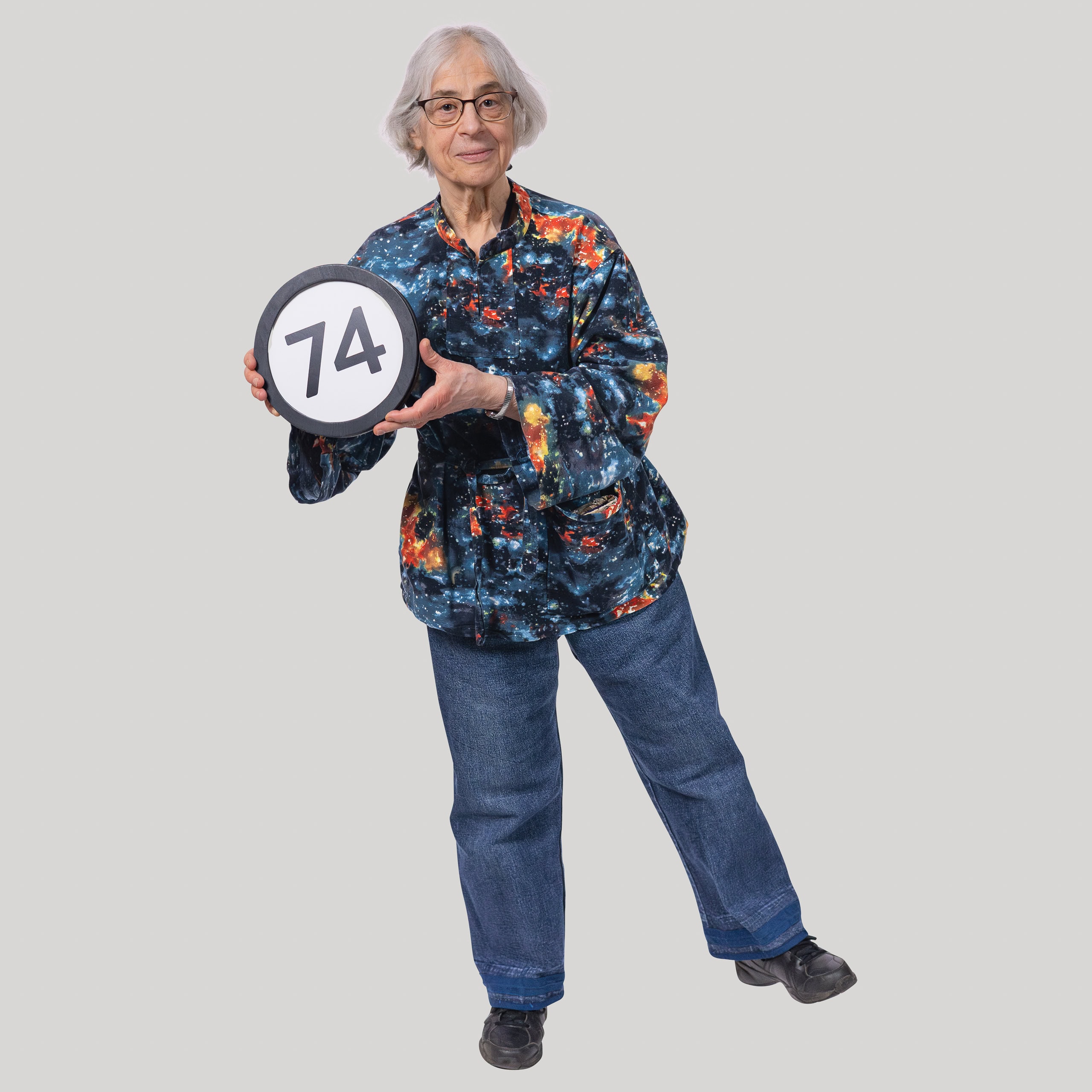 74 year old woman holds the number 74 in the 1 to Infinity, MIT portrait series by Danny Goldfield.