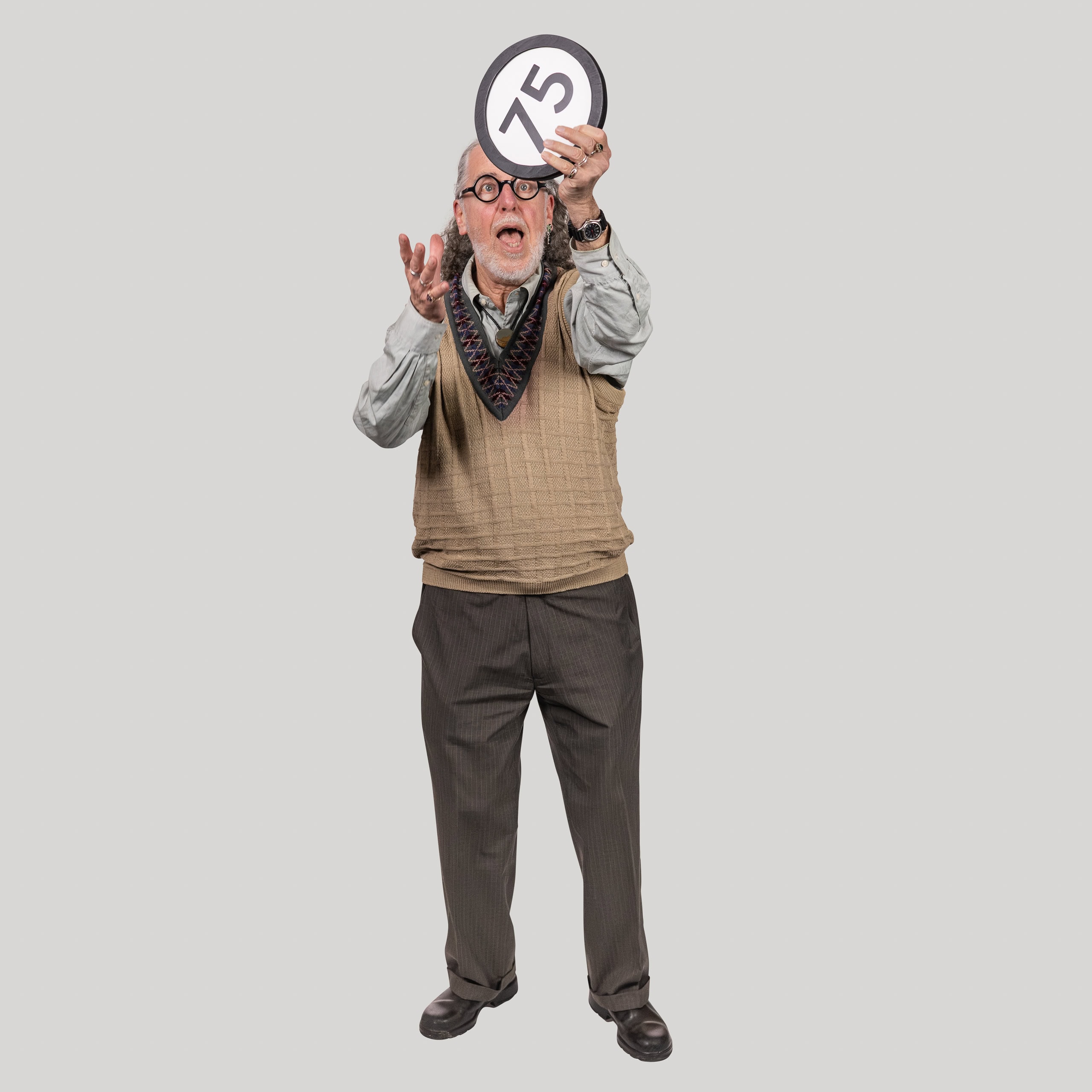 75-year-old man holds the number 75 in the 1 to Infinity, MIT portrait series by Danny Goldfield.